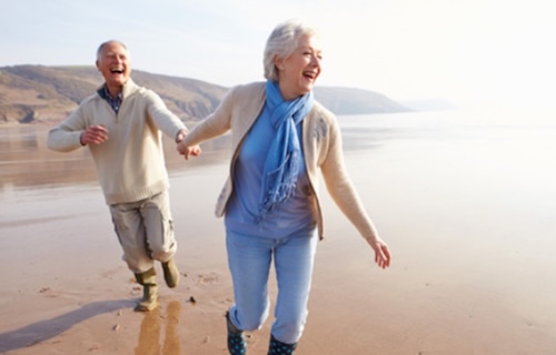 Retirees on a beach, walking